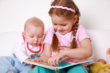 Image showing Adorable kids reading and playing