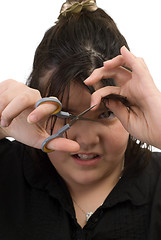 Image showing Child Cutting Own Hair