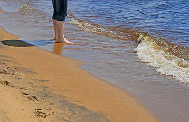 Image showing Man standing in water on a beach