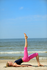 Image showing Sporty female workout on the beach