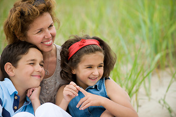 Image showing happy mother and kids on the beach