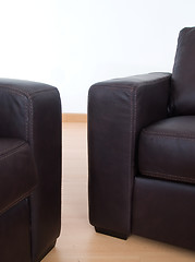 Image showing Detail of two brown leather sofas