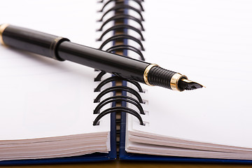 Image showing pen over a notepad