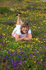 Image showing Young girl enjoying on a flowers meadow