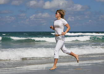 Image showing Running woman on the beach