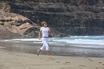 Image showing Running woman on the beach