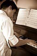 Image showing Asian man playing piano