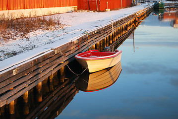Image showing Wooden Pier And Boat Reflected in Water