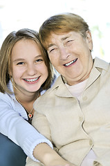 Image showing Granddaughter hugging grandmother