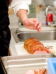 Image showing Chef preparing ham in kitchen