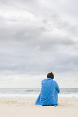 Image showing Lonely woman sitting on beach