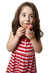 Image showing Young girl eating doughnut