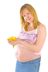 Image showing pregnant woman with yellow flowers