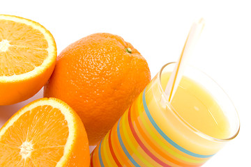 Image showing glass of juice and oranges