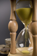 Image showing sand clock and coin