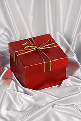 Image showing red gift box on white satin