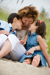 Image showing Happy mother and kids on the beach