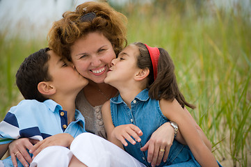 Image showing Happy mother and kids on the beach