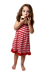 Image showing Little girl eating doughnut