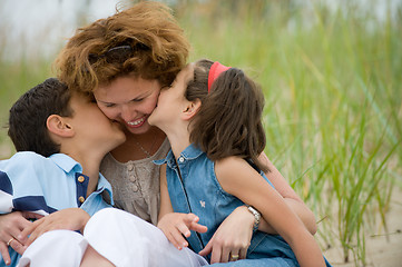 Image showing Happy mother and kids on the beach