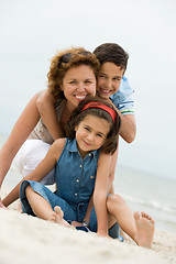 Image showing Happy mother and kids on the beach