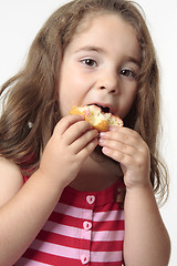 Image showing Child eating junk food donut.