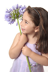 Image showing Pretty girl holding a beautiful flower