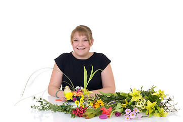 Image showing Young girl arranging flowers 