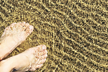 Image showing Feet in shallow water