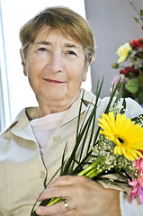 Image showing Elderly woman with flowers