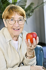 Image showing Elderly woman with apple