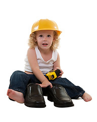 Image showing Little boy with grown up man shoes