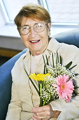 Image showing Elderly woman with flowers