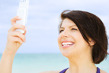 Image showing happy woman with phone on the beach