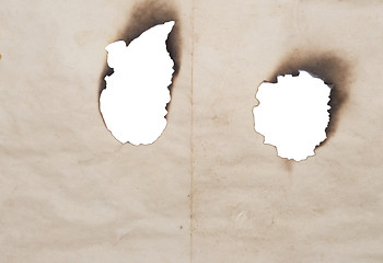 Image showing burnt holes in old paper