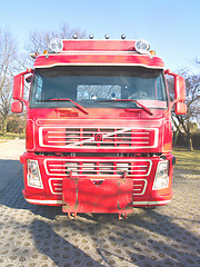 Image showing Front view of a red truck in urban area