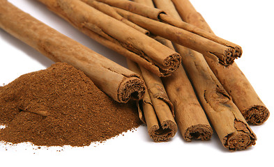 Image showing cinnamon powder and bark isolated on white