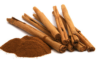 Image showing cinnamon powder and bark isolated on white