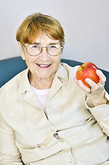 Image showing Elderly woman with apple