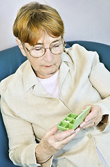 Image showing Elderly woman with pill box