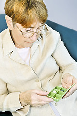 Image showing Elderly woman with pill box