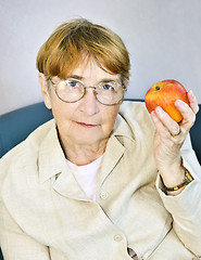 Image showing Elderly woman with apple
