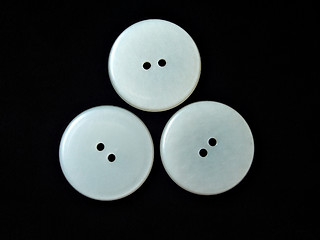 Image showing three round white buttons