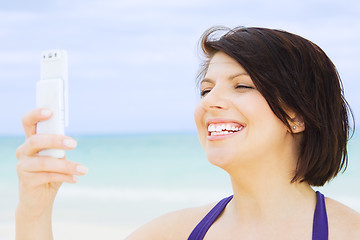 Image showing happy woman with phone on the beach