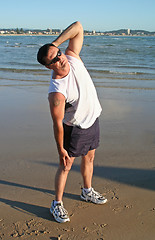 Image showing Stretching Exercises On The Beach