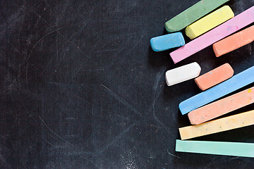 Image showing blackboard with coloured crayons