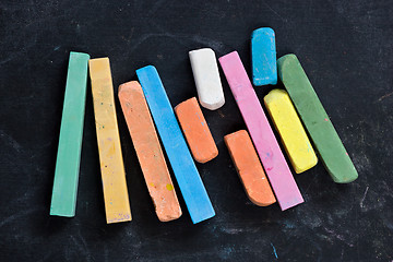Image showing blackboard with coloured crayons