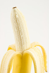 Image showing One cleared banana on light background