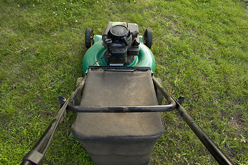 Image showing Pushing a Lawn Mower