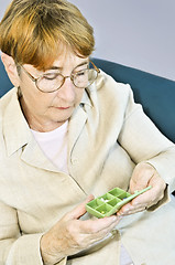 Image showing Elderly woman with pill box